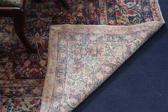 A Kirman ivory ground carpet,